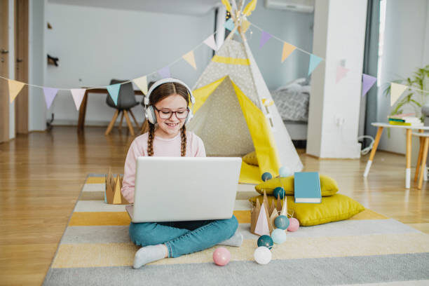 Girl on her laptop sitting on plush area rug